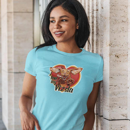 woman leaning against a wall wearing a light blue tee featuring the I love my Vizsla design on the front - original hungarian vizsla artwork gift